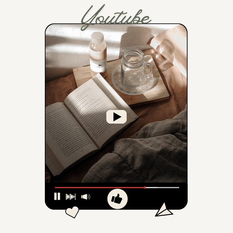 Open book on a wooden table with a glass mug and bottle, resembling a YouTube video interface.